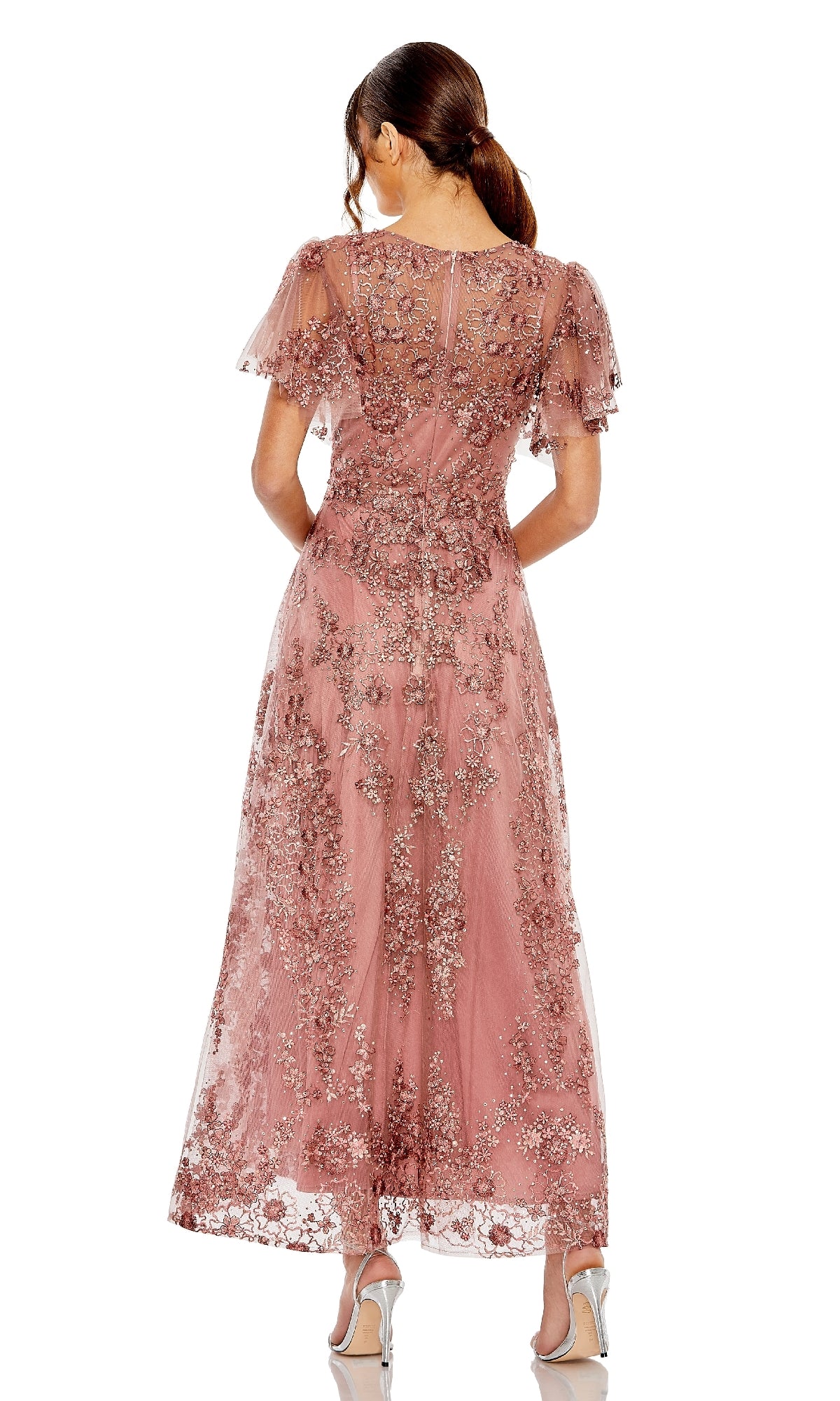 Woman wearing a mauve pink a-line dress on a white background